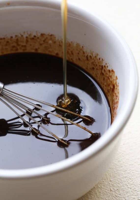 Honey garlic sauce is whisked together in a mixing bowl.