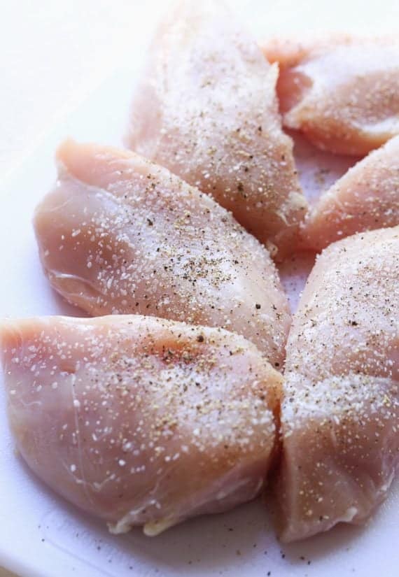 Chicken breasts seasoned with salt and pepper.
