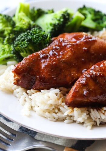 Slow cooker honey garlic chicken served on a bed of rice with broccoli.