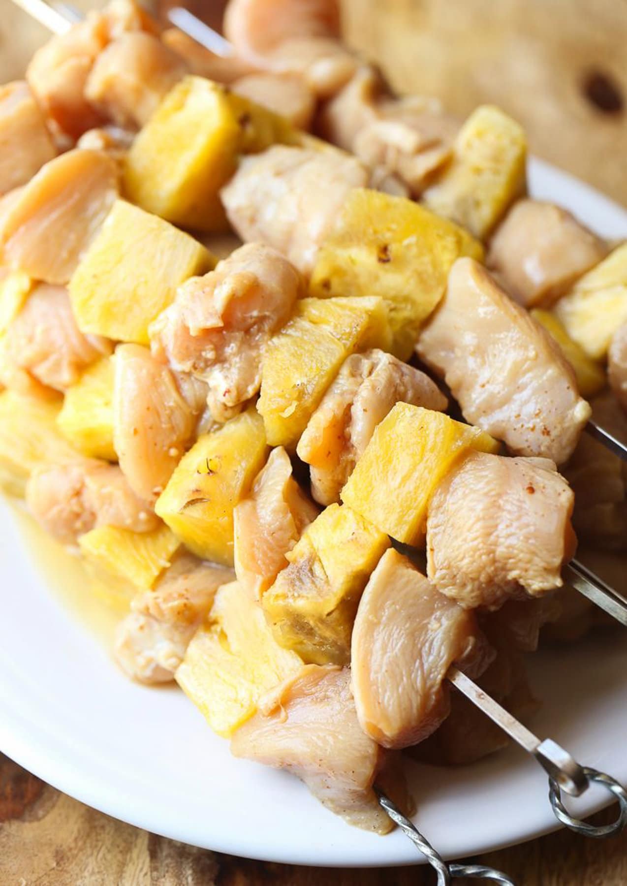Raw chicken and pineapple on a skewer