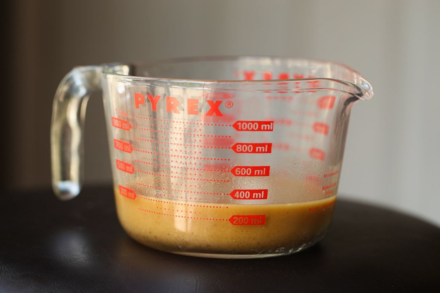 Chicken marinade in a measuring cup