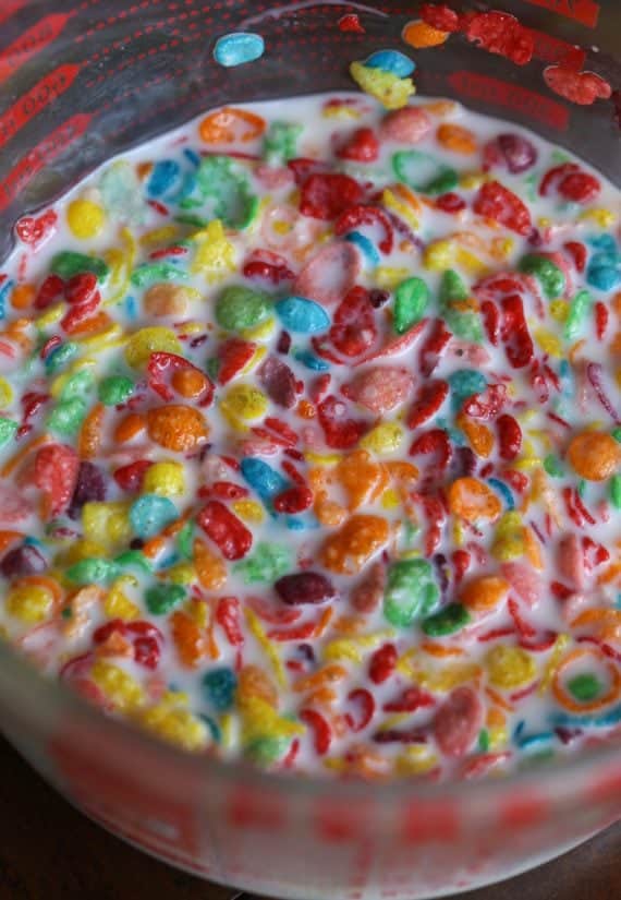 Close-up of Fruity Pebbles Cereal in milk in a glass measuring cup