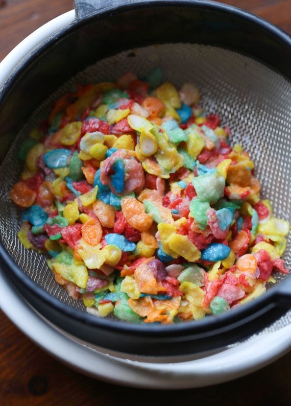 Fruity Pebbles in a mesh strainer after being soaked in milk
