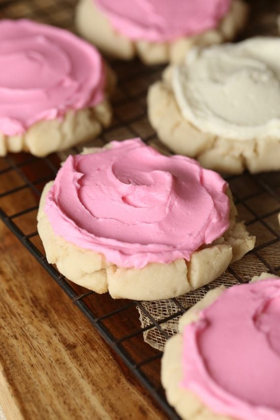 Pressed Sugar Cookies! Soft in the center, with lightly crunchy edges, piled with creamy frosting! Sorta kinda like the famous Swig Cookie!
