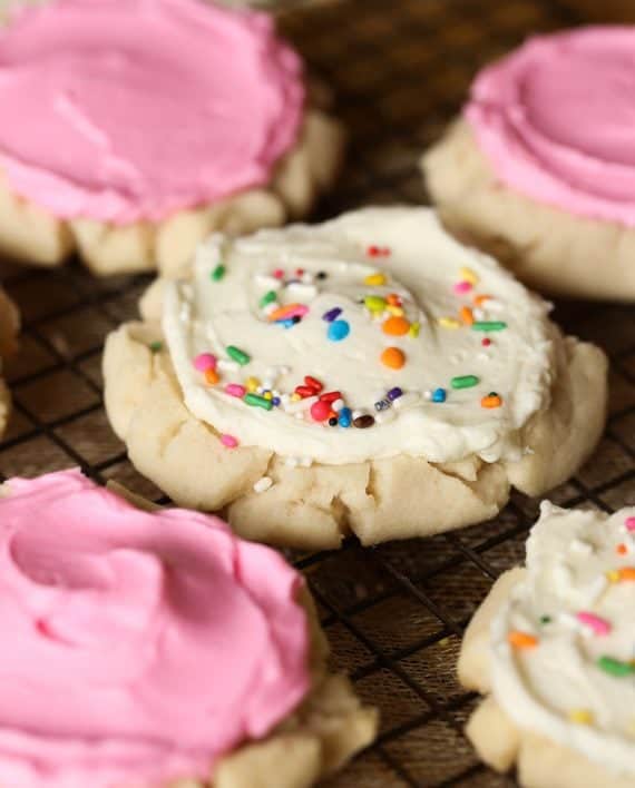Pressed Sugar Cookies! Soft in the center, with lightly crunchy edges, piled with creamy frosting! Sorta kinda like the famous Swig Cookie!