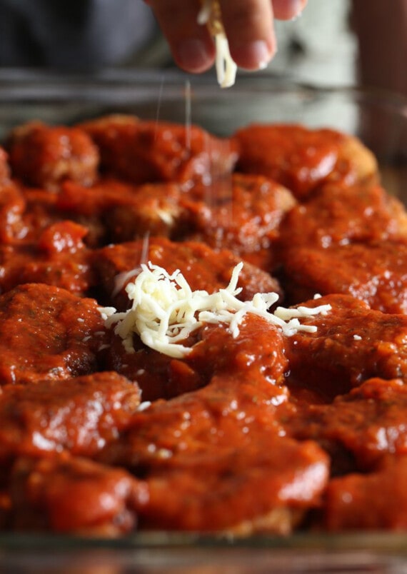 These cheesy chicken parmesan sliders are the best party food! An easy game day appetizer or kid-friendly dinner that's ready in 30 minutes. A sprinkle of shredded mozzarella cheese added on top of chicken and sauce on slider buns.