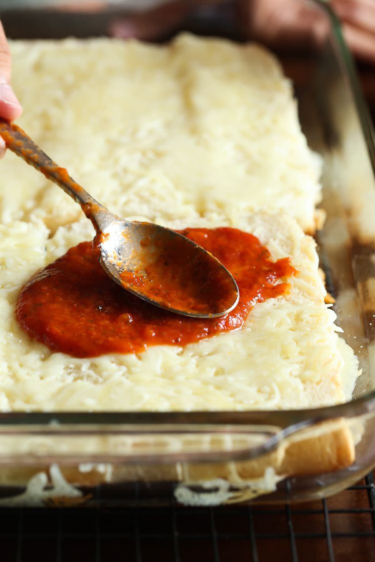 Tomato sauce spread on cheese