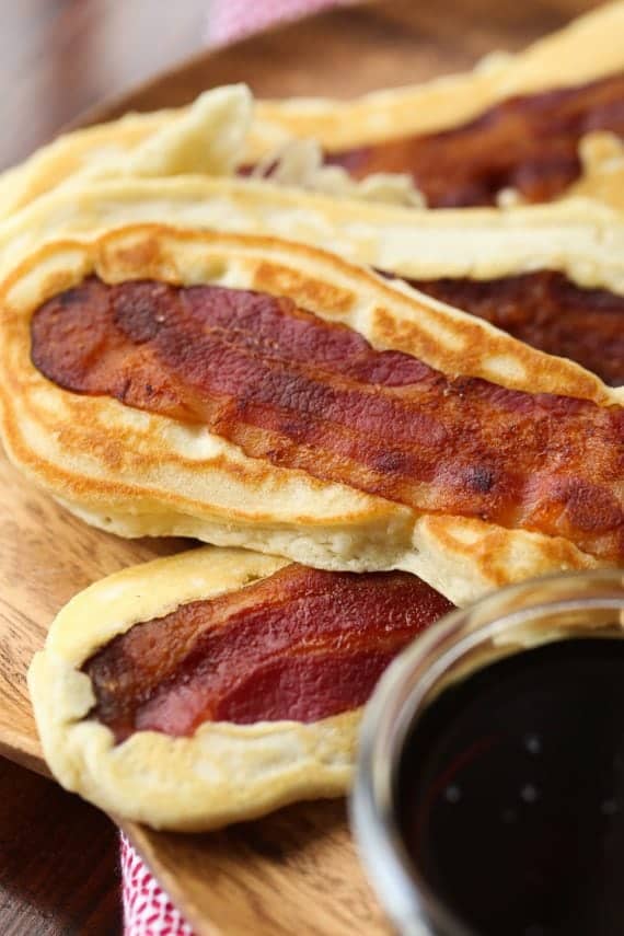 Pancake Bacon Dippers! A soft pancake surrounds a crispy piece of bacon that you can dip right in maple syrup!