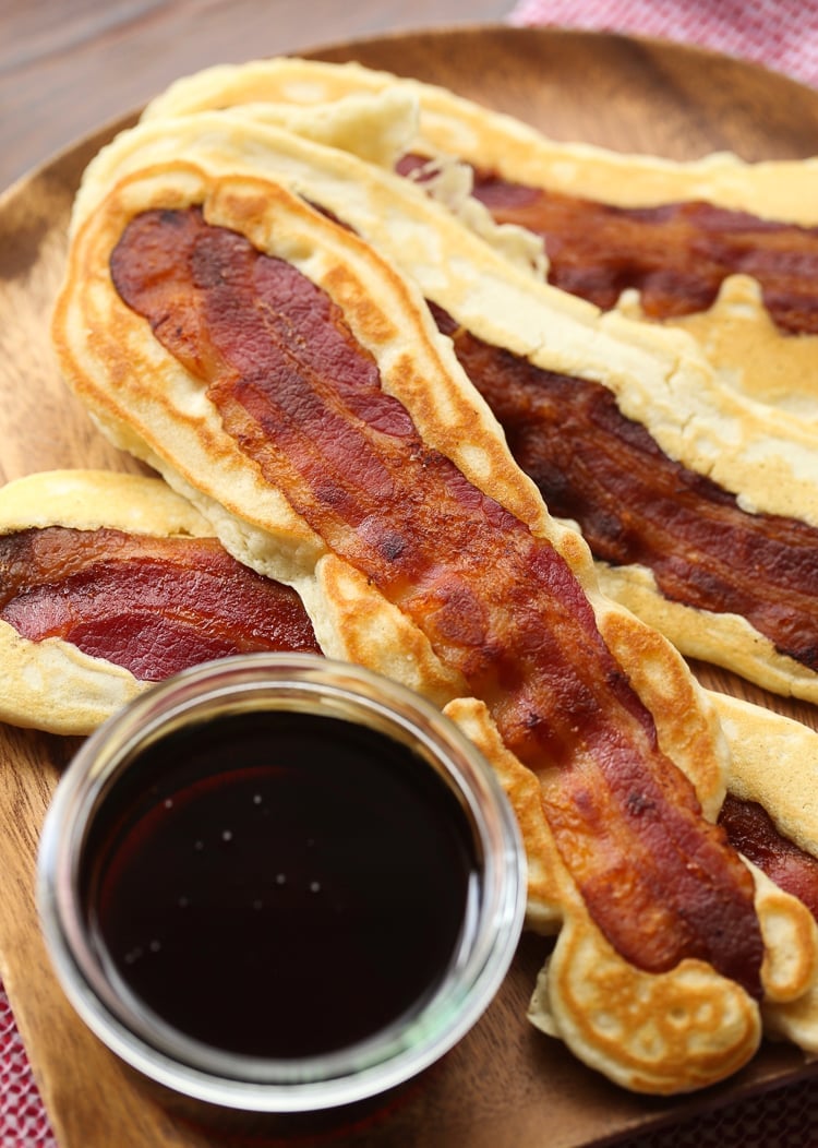 Pancake Bacon Dippers! A soft pancake surrounds a crispy piece of bacon that you can dip right in maple syrup!