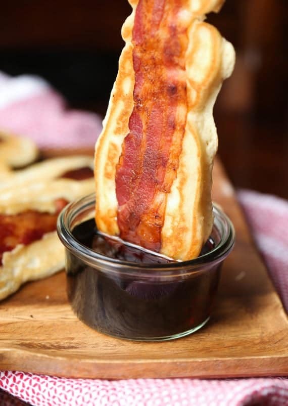 Pancake Bacon Dippers! A soft pancake surrounds a crispy piece of bacon that you can dip right in maple syrup!