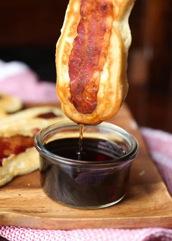 Pancake Bacon Dippers! A soft pancake surrounds a crispy piece of bacon that you can dip right in maple syrup!