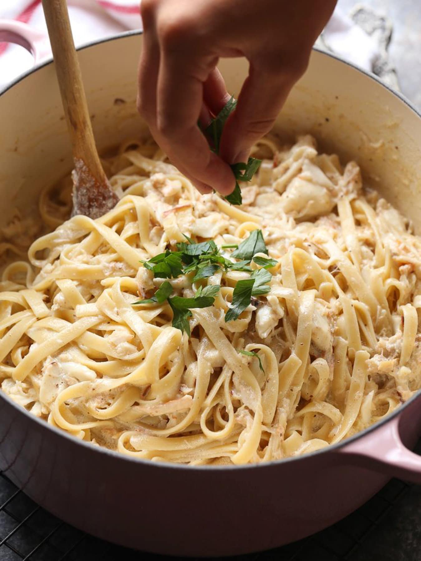 Parsley mixed into crab pasta