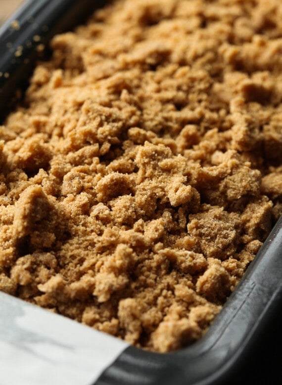 Close up of the unbaked crumble topping on pumpkin banana bread.