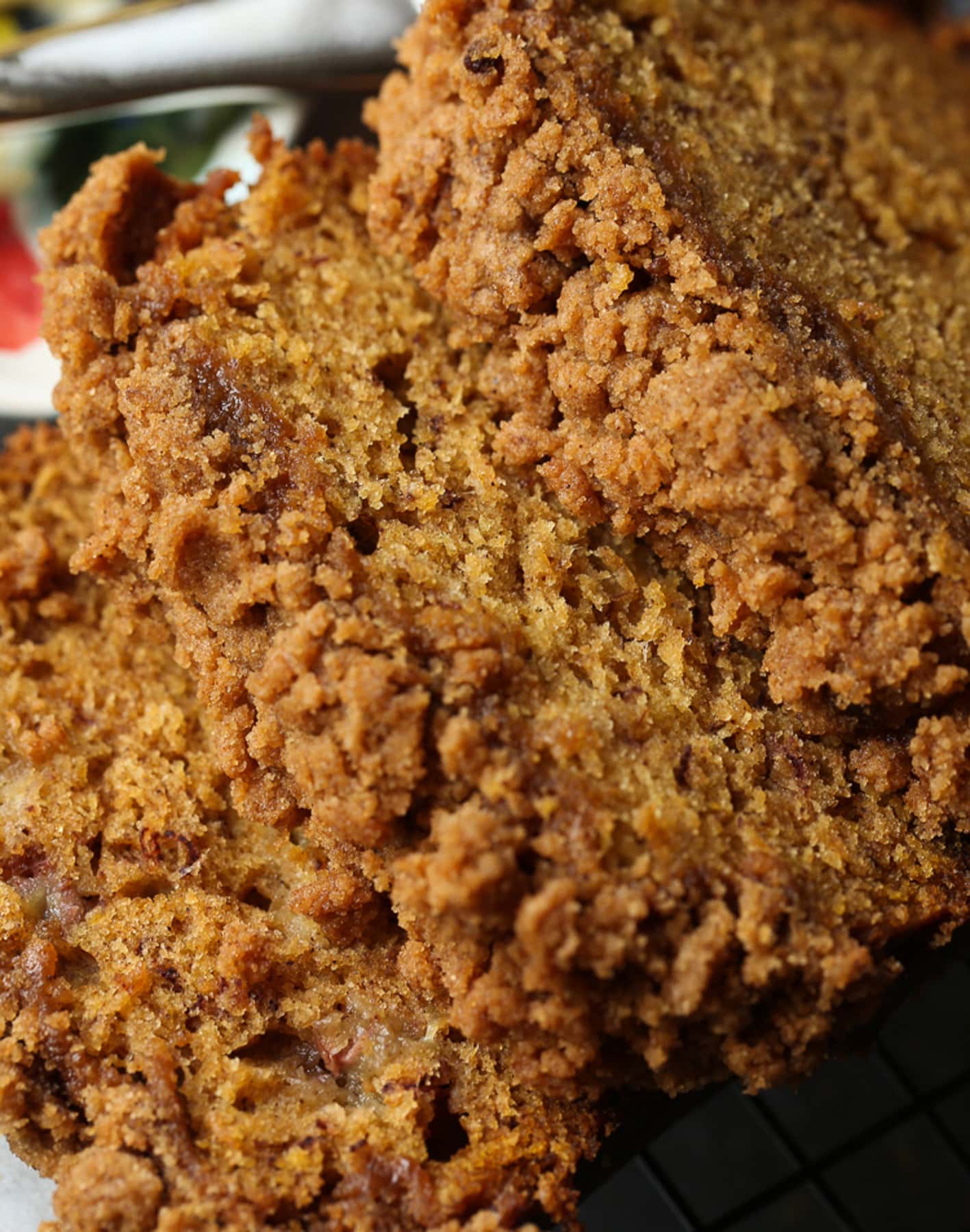 Close up of three slices of pumpkin banana bread with a crumble.