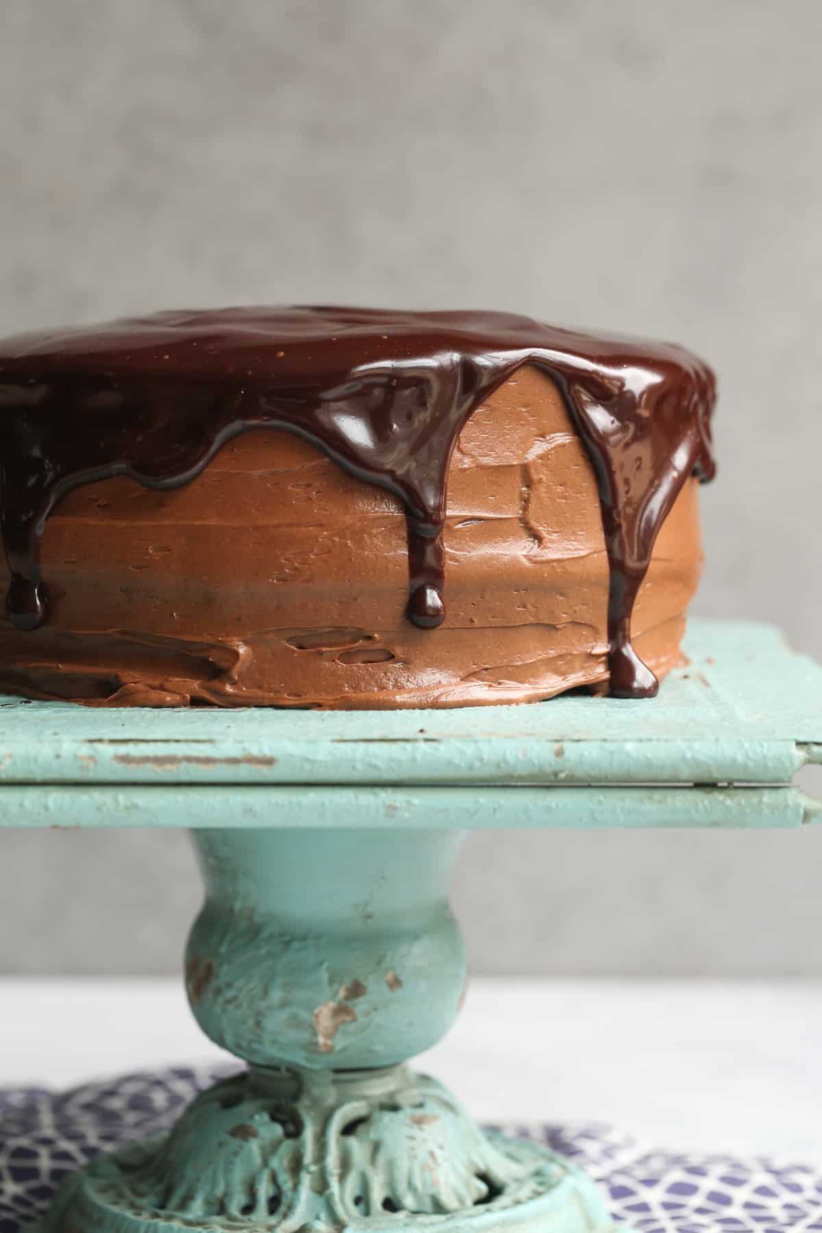 Perfect Chocolate Cake topped with chocolate frosting and chocolate ganache