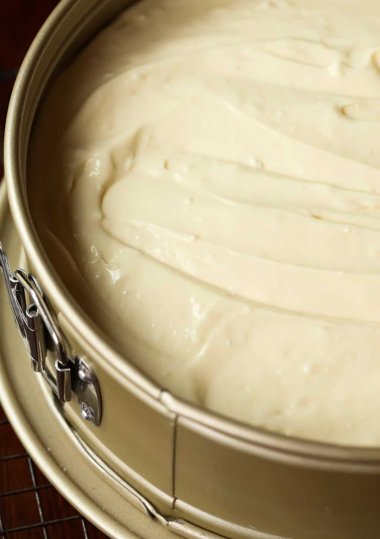 Homemade cheesecake in a springform pan ready to be baked.