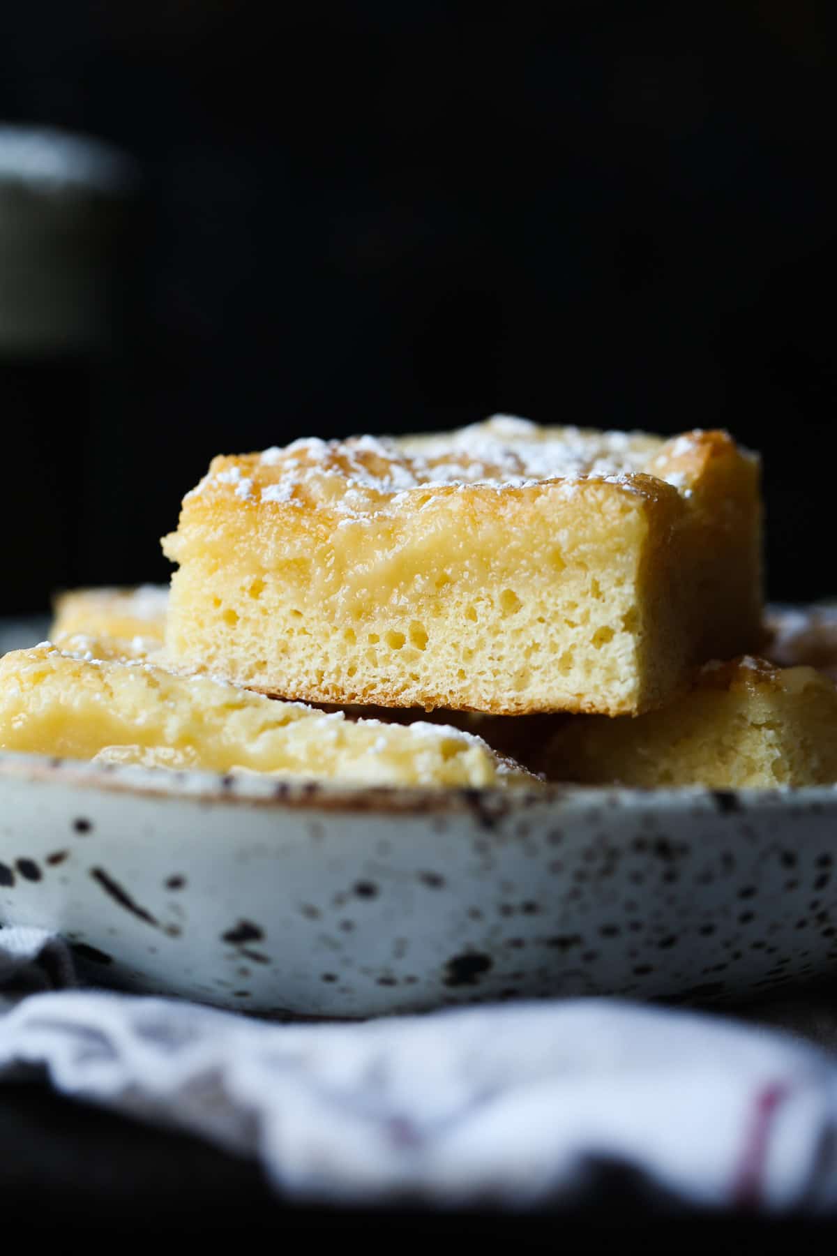 German butter cake pieces stacked on a plate