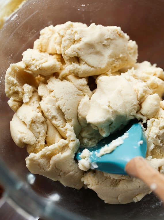 A blue spoon stirring shortbread dough