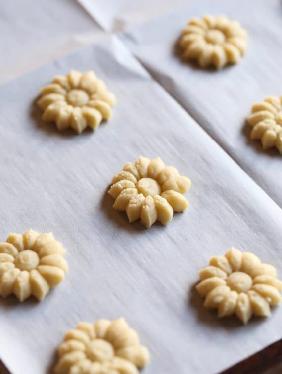 Unbaked spritz cookies on a baking sheet