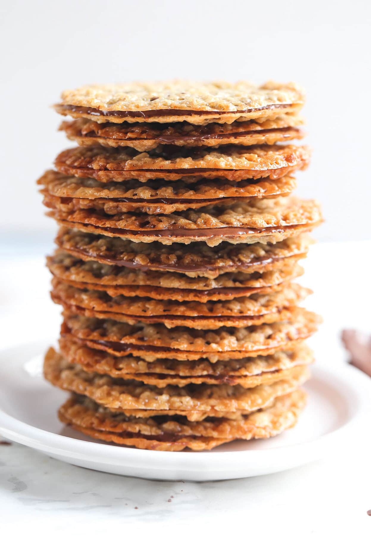 Milk Chocolate Lace Sandwich Cookies stacked on top of each other