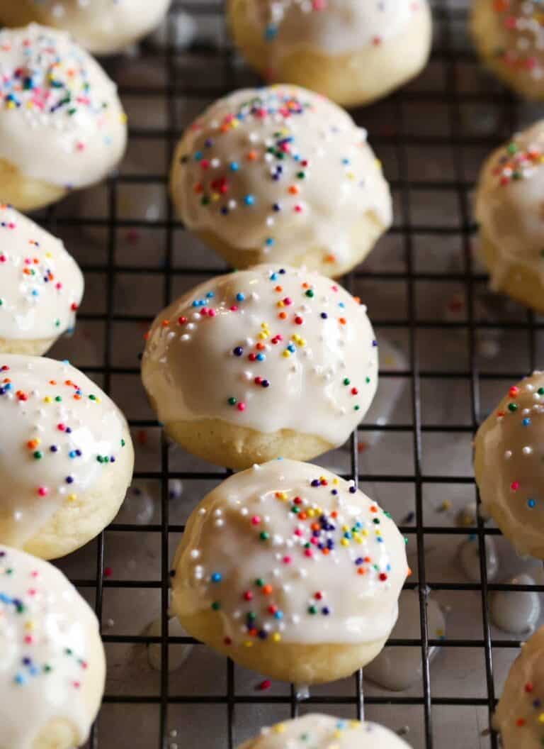 Glazed Italian Ricotta Cookies lined up on a wire rack.