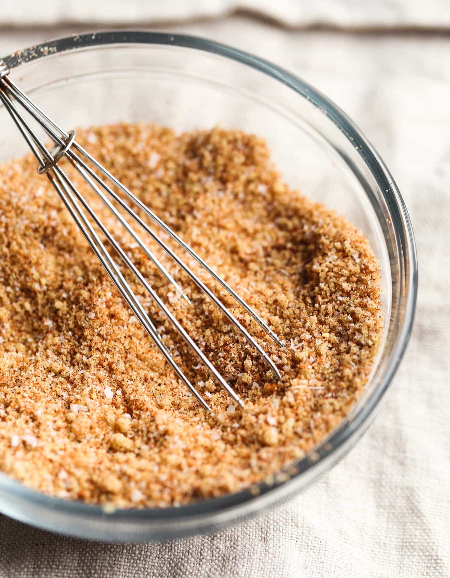 A whisk is used to combine the ingredients for the chicken dry rub.