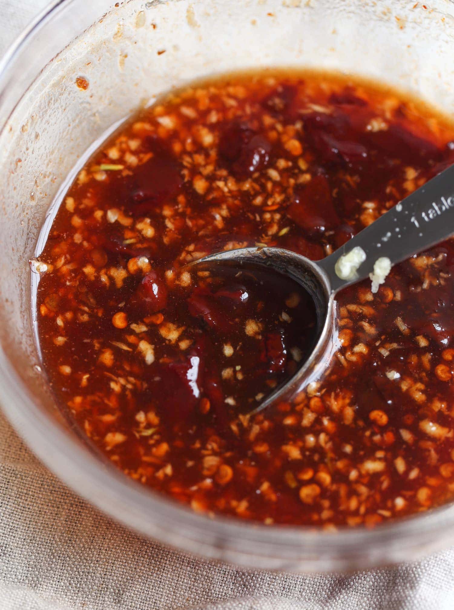 Honey chipotle sauce in a mixing bowl with a spoon.