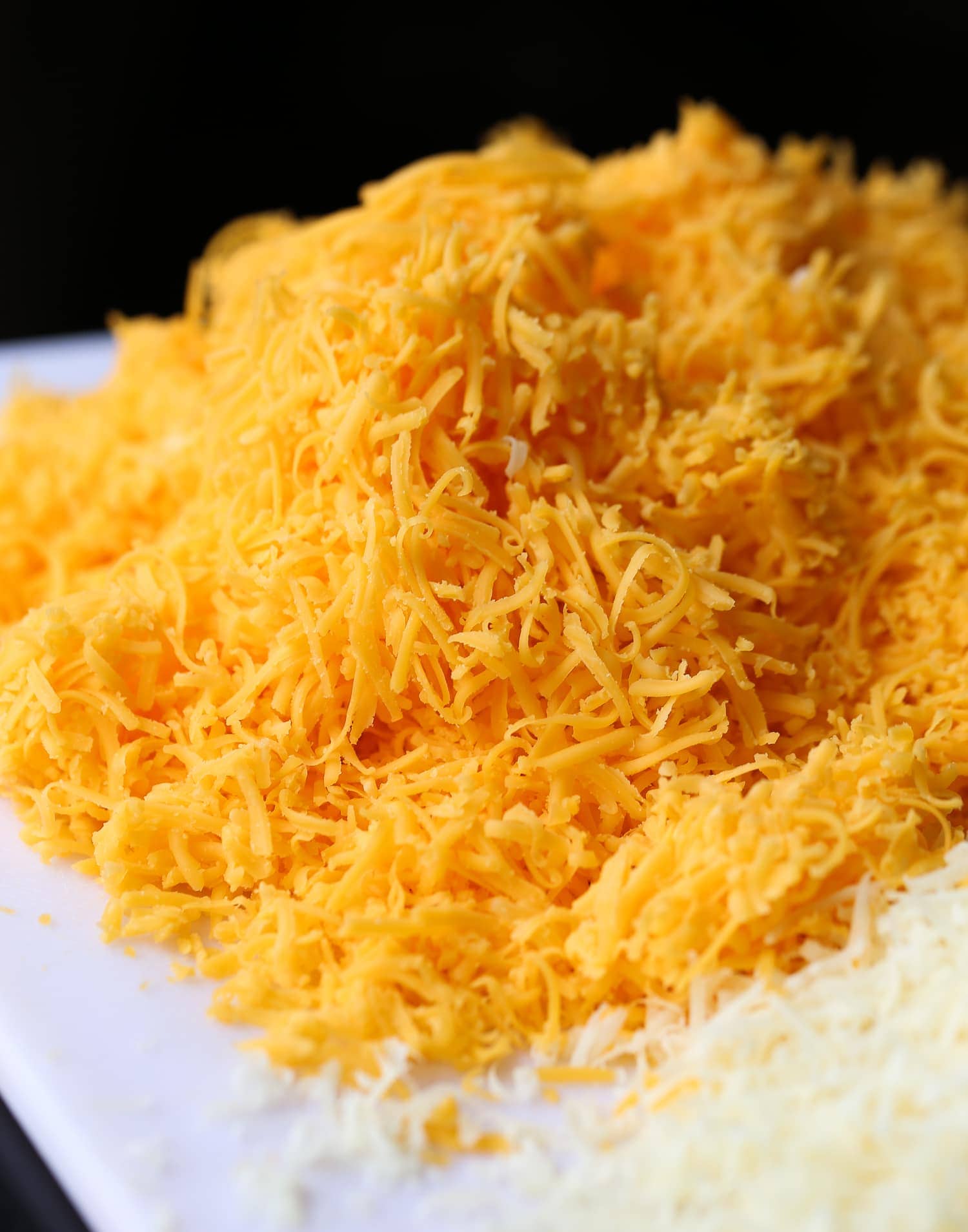 A pile of grated cheddar cheese