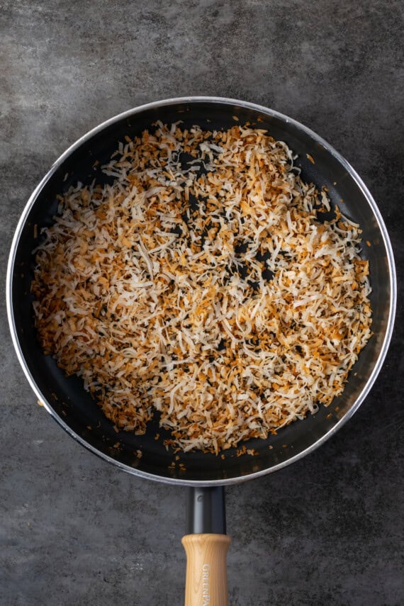 Toasted shredded coconut in a skillet.