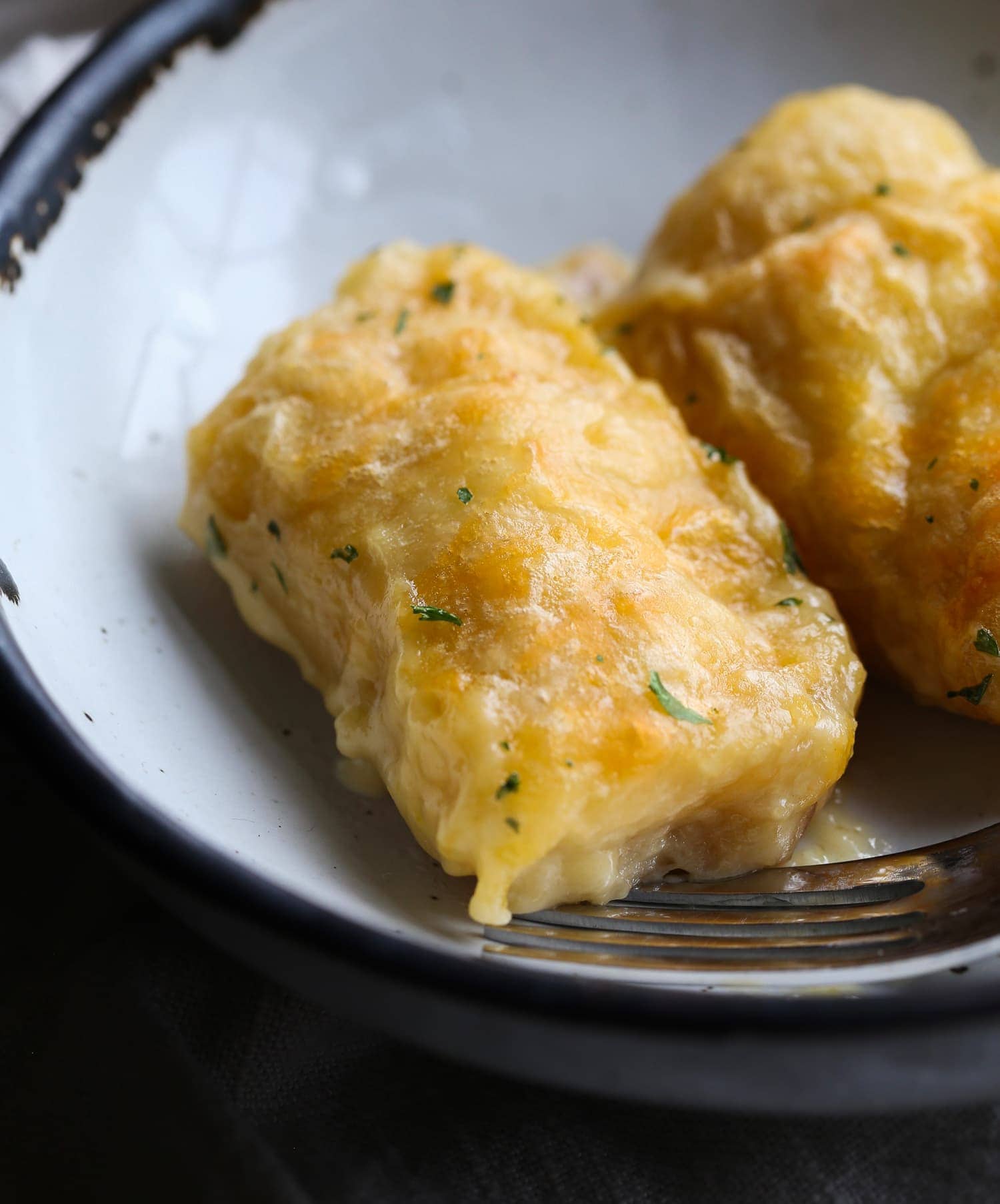 Cheesy baked chicken stuffed crescent rolls on a plate