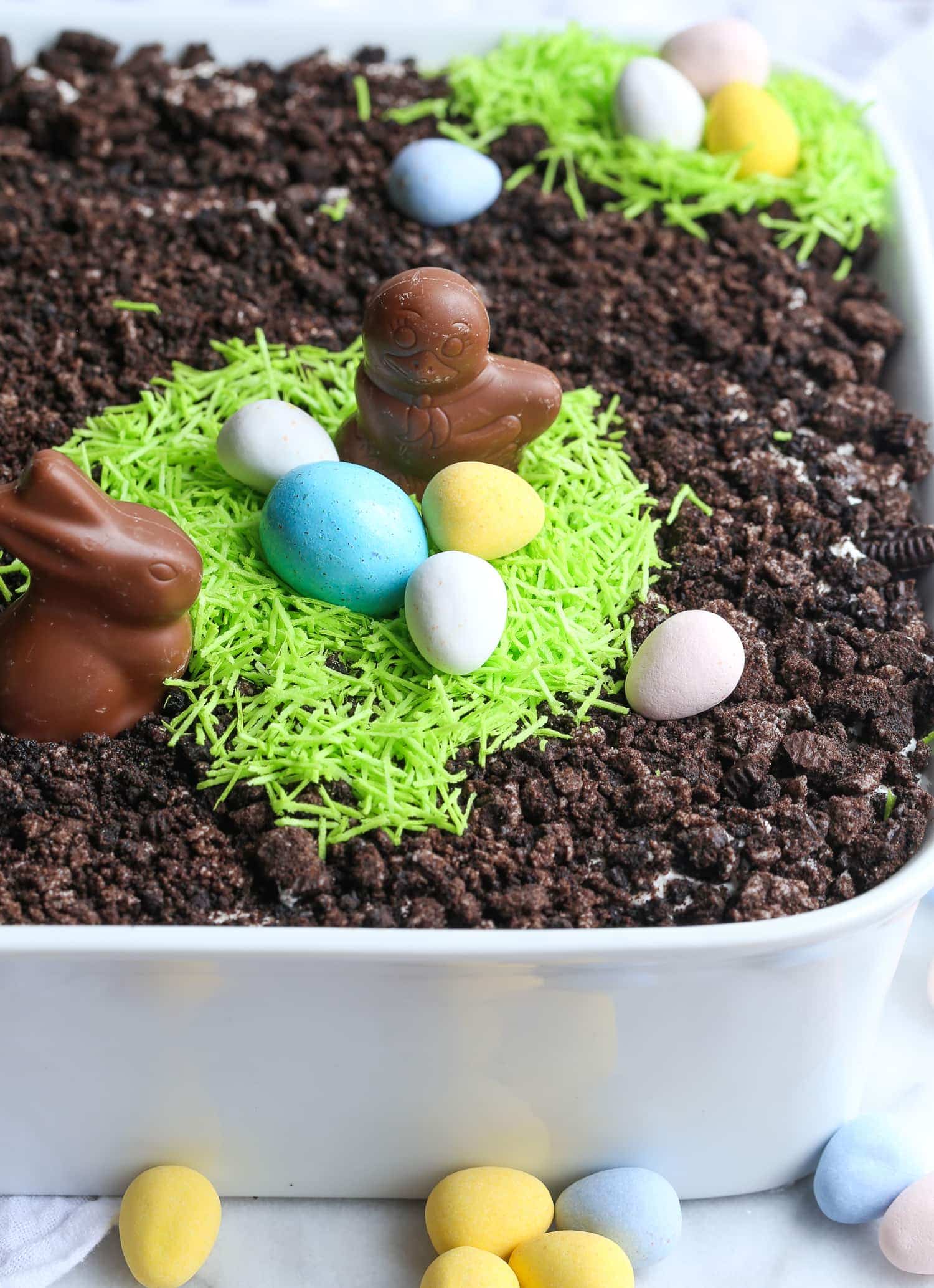 Easter Bunny Dirt Cake in a baking dish, topped with crushed cookies and Easter candy.