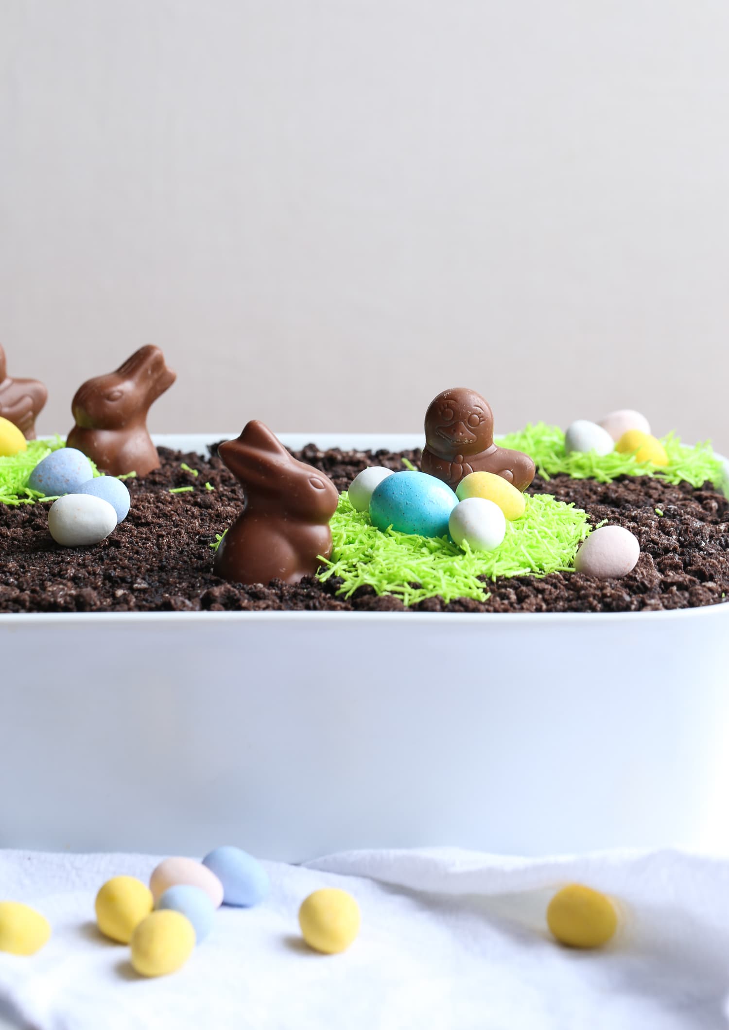 Easter Bunny Dirt Cake in a baking dish, topped with crushed cookies and Easter candy.