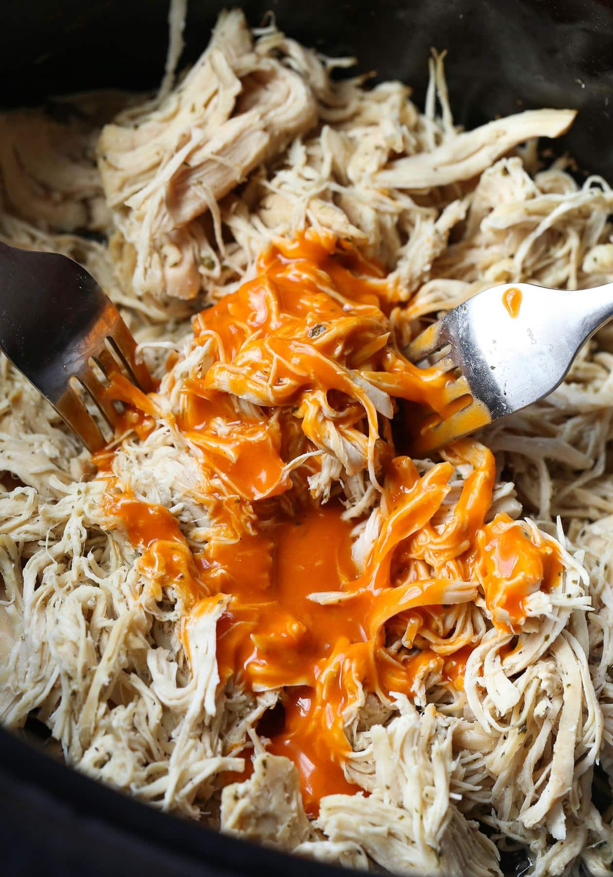 Shredded chicken topped with buffalo sauce