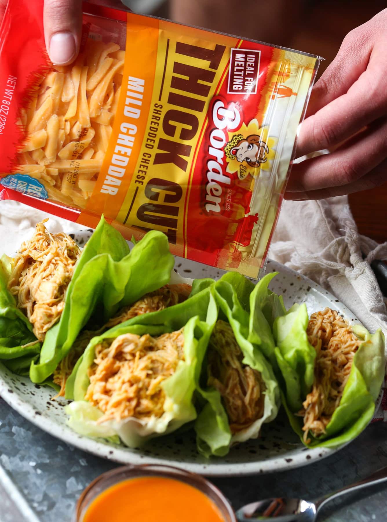 Topping lettuce wraps with cheese