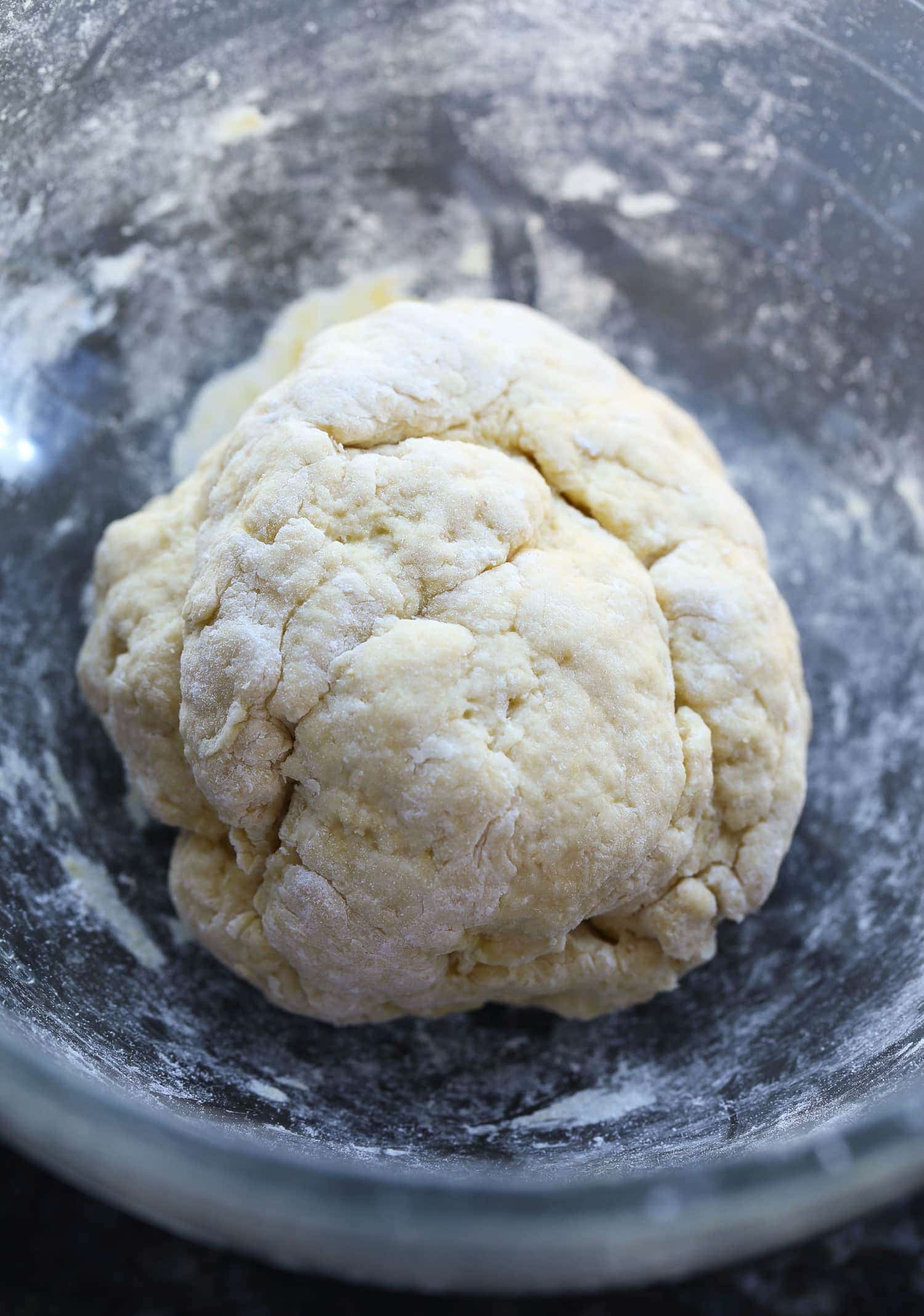 Egg noodle pasta dough in a mixing bowl before being kneaded