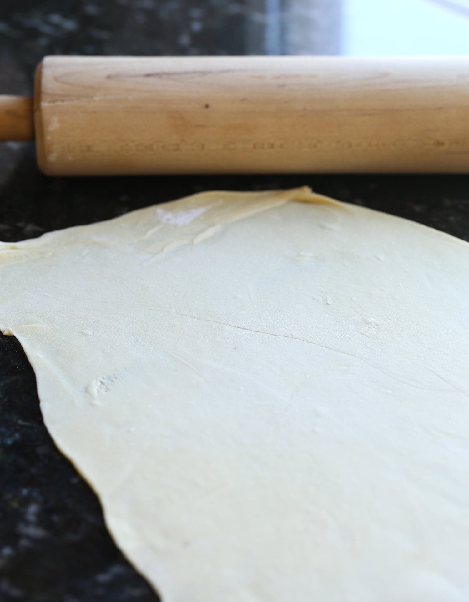 A sheet of rolled out egg noodle dough