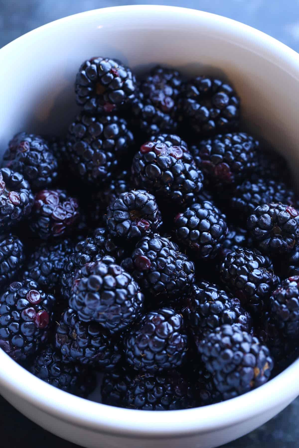 A bowl of blackberries in a white bowl