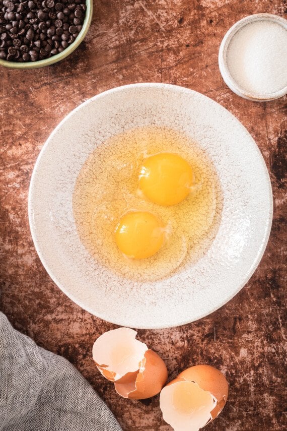 Two eggs cracked in a bowl.