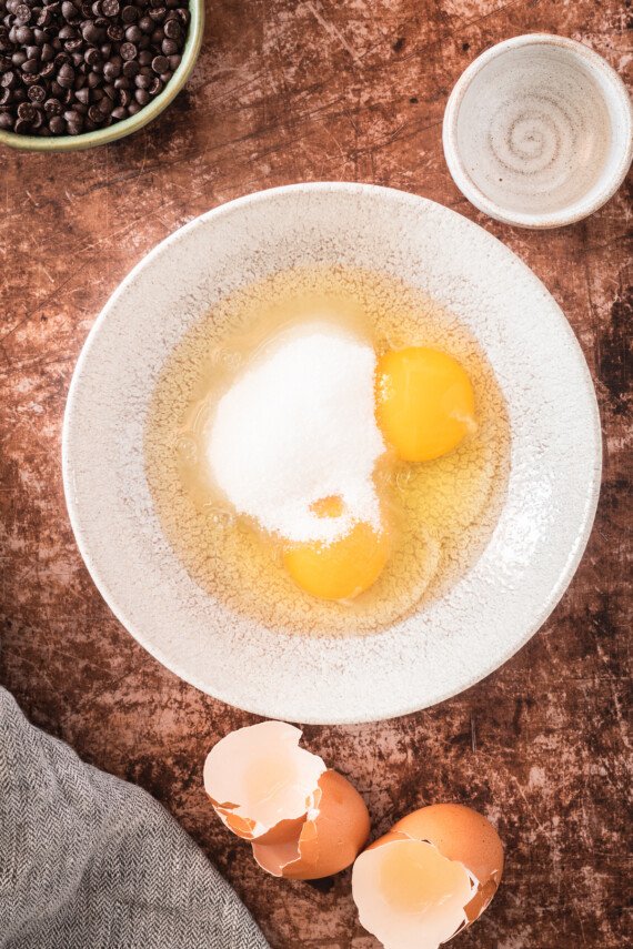 Eggs and sugar in a bowl.