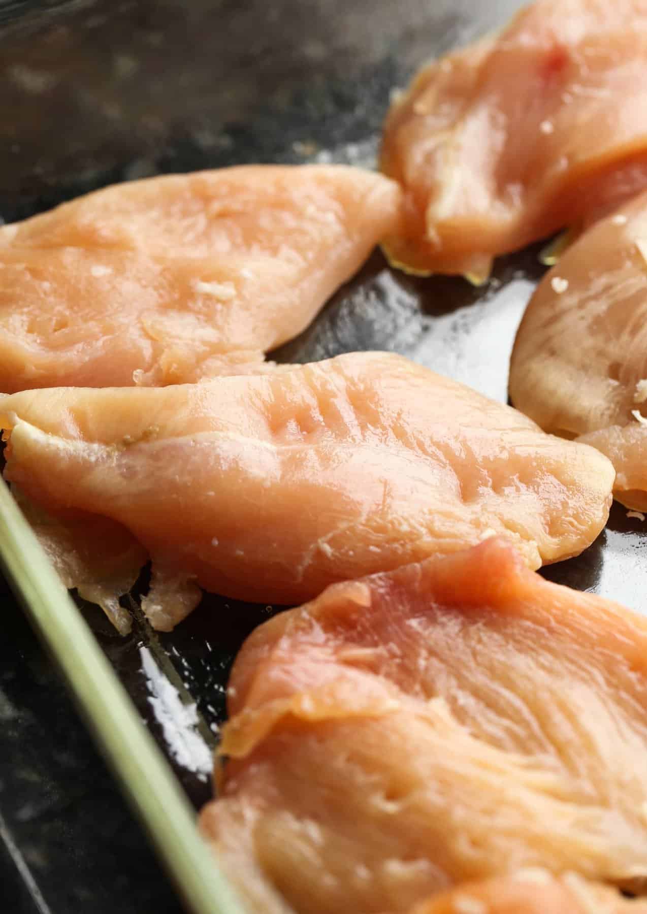 raw chicken in a baking dish