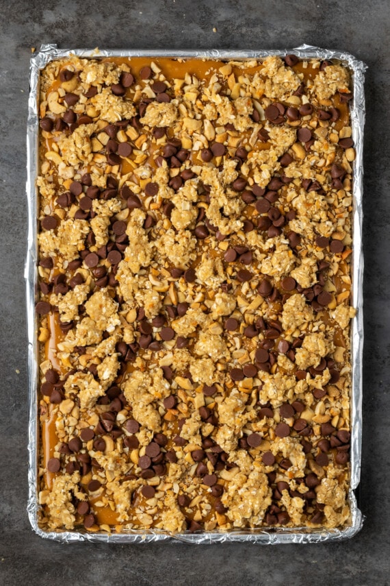 Baked caramel oat bars in a lined sheet pan.