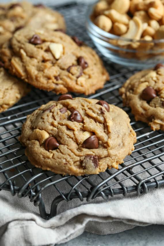 Salted Toffee Cashew Chocolate Chip Cookies on a wire cooling rack
