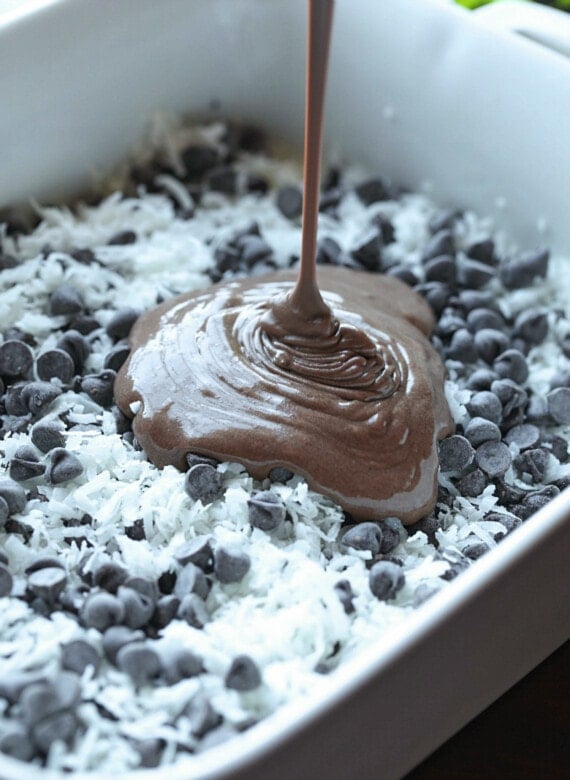 Chocolate cake batter poured over shredded coconut and chocolate chips.