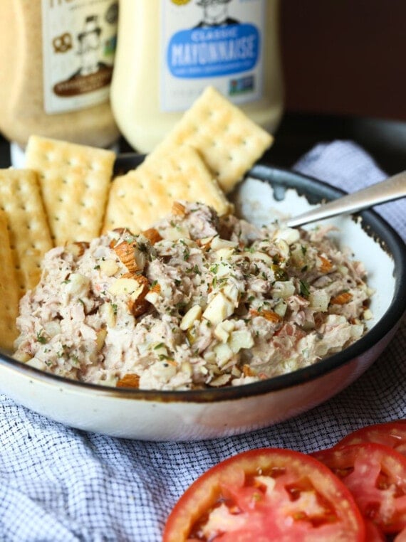 Tuna salad served in a bowl with crackers.