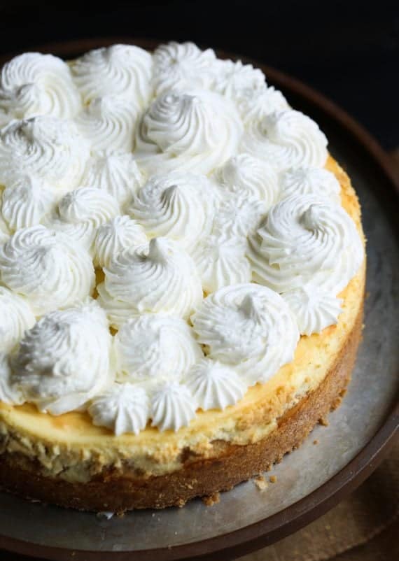 Swirls of whipped cream on top of a banana pudding cheesecake.