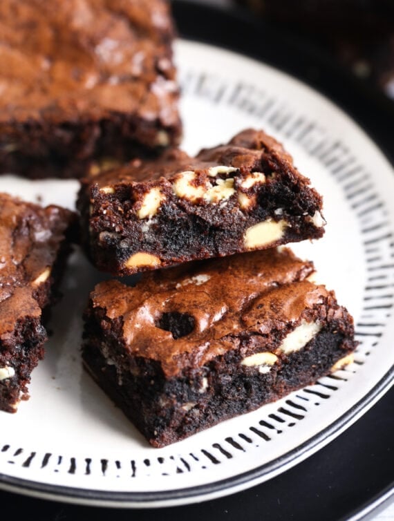 Brownies on a plate showing white chocolate chips and oreos on the inside