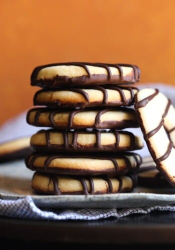 A stack of homemade fudge stripe cookies on a plate.