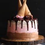 Neapolitan Cake topped with three upside-down ice cream cones.