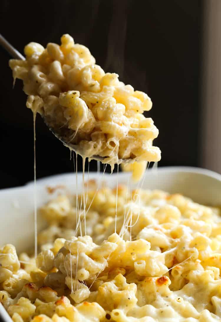 A spoonful of Midwest 5 cheese bake lifted out of a casserole dish.