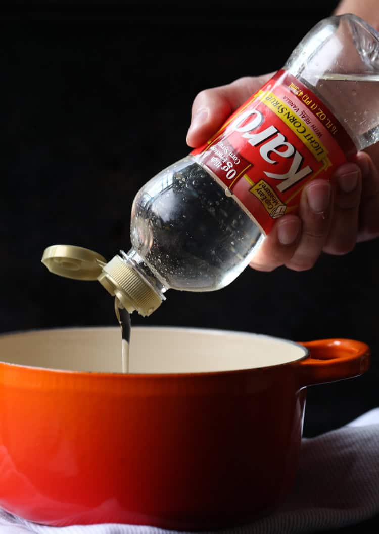 Karo Corn Syrup is poured into a saucepan.